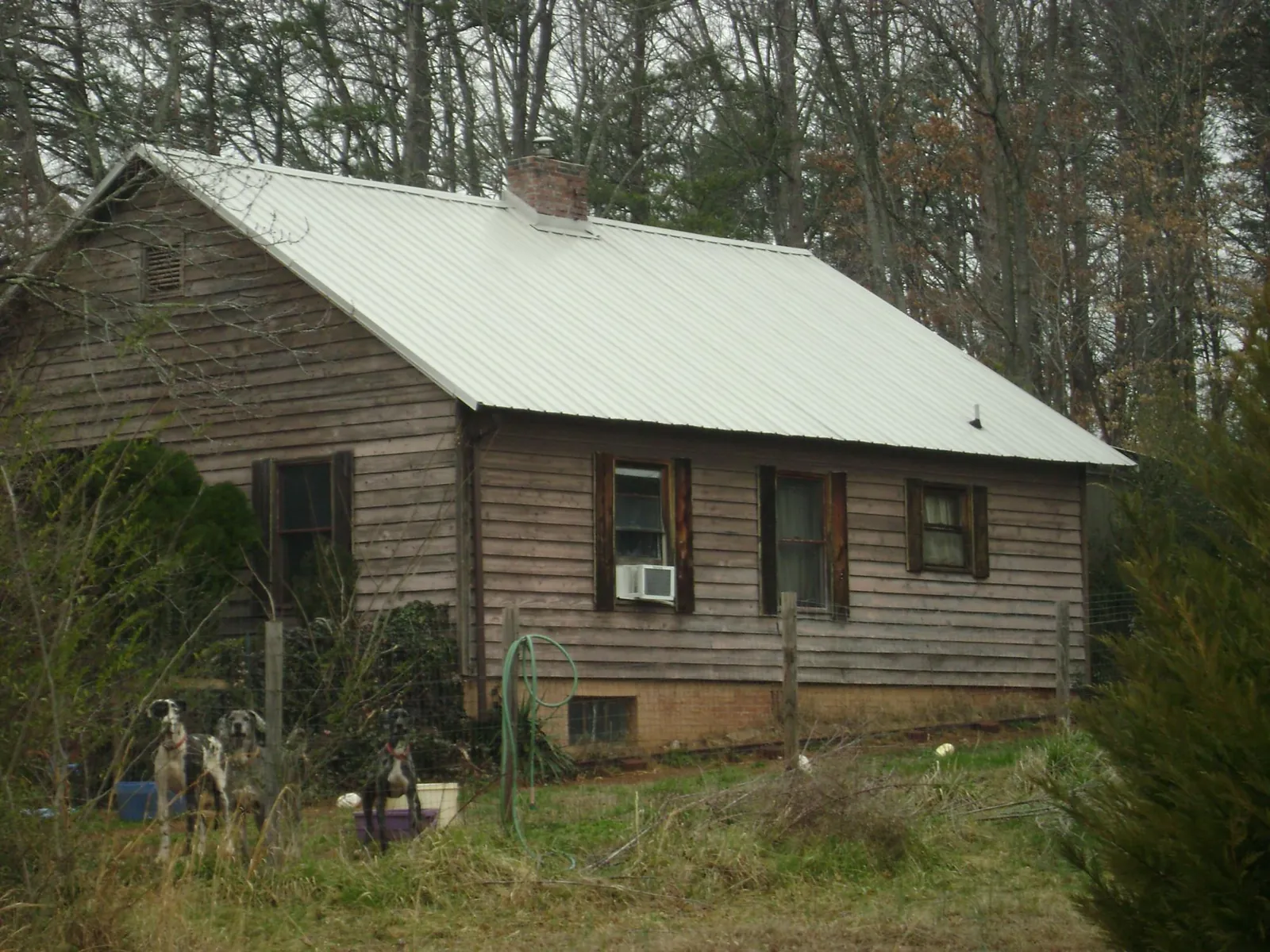 White metal roof on an old wood sided farmhouse, from a Metal Roof Installation job in Fletcher